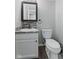 A half bath featuring a granite countertop, stylish mirror, and a toilet at 5852 Long Ridge Pl, Indianapolis, IN 46221