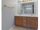 Bathroom featuring a double sink vanity with a large mirror and modern fixtures at 5852 Long Ridge Pl, Indianapolis, IN 46221