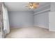 Spacious carpeted bedroom with ceiling fan, shelf, and natural light from the window at 5852 Long Ridge Pl, Indianapolis, IN 46221