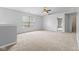 A large, bright bedroom with a ceiling fan and a view from the window, creating a comfortable atmosphere at 5852 Long Ridge Pl, Indianapolis, IN 46221