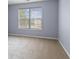 Bright bedroom with large window, carpet, and neutral walls, creating a comfortable space at 5852 Long Ridge Pl, Indianapolis, IN 46221