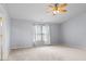 A bright primary bedroom with a ceiling fan and a large window providing natural light at 5852 Long Ridge Pl, Indianapolis, IN 46221