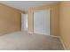 Cozy bedroom with plush carpeting, closet, and neutral walls, creating a comfortable space at 5852 Long Ridge Pl, Indianapolis, IN 46221
