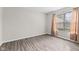 A bright bedroom with a window letting in natural light and wood-style floors, and neutral walls at 5852 Long Ridge Pl, Indianapolis, IN 46221