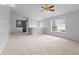 A large upstairs bonus room with a ceiling fan, a window and access to other areas of the house at 5852 Long Ridge Pl, Indianapolis, IN 46221