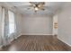 Dining room with neutral paint, hardwood floors, ceiling fan and a large window with sheer curtains at 5852 Long Ridge Pl, Indianapolis, IN 46221