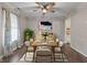 Dining room with neutral paint, hardwood floors, ceiling fan and a large window with sheer curtains at 5852 Long Ridge Pl, Indianapolis, IN 46221
