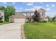 Charming two-story brick home featuring an attached two car garage and a well manicured front yard at 5852 Long Ridge Pl, Indianapolis, IN 46221