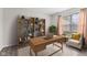 A stylish home office featuring a desk, comfortable seating, and a bookshelf filled with decorative items at 5852 Long Ridge Pl, Indianapolis, IN 46221