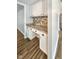 Bright kitchen featuring white cabinetry, granite countertops, and stylish backsplash, seamlessly blending functionality with elegant design at 5852 Long Ridge Pl, Indianapolis, IN 46221