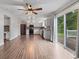 The kitchen features stainless steel appliances, white cabinets and hardwood flooring, with a view to the patio at 5852 Long Ridge Pl, Indianapolis, IN 46221
