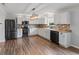 The kitchen features stainless steel appliances, white cabinets and hardwood flooring at 5852 Long Ridge Pl, Indianapolis, IN 46221
