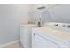 Convenient laundry room featuring a washer and dryer, as well as wire shelving for storage at 5852 Long Ridge Pl, Indianapolis, IN 46221