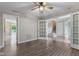 Bright living room featuring wood floors, a ceiling fan, and french doors leading to other areas of the house at 5852 Long Ridge Pl, Indianapolis, IN 46221