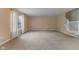 Spacious living room with neutral paint, plush carpet and natural light from a window with sheer curtains at 5852 Long Ridge Pl, Indianapolis, IN 46221