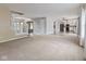 An open concept living room with plush carpet and connecting rooms with hardwood floors at 5852 Long Ridge Pl, Indianapolis, IN 46221