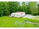 Aerial view of a house with a metal roof, dog kennel and surrounding lush greenery, on a sprawling lot at 5858 N West Shore Dr, Morgantown, IN 46160