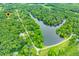 An aerial view showcases homes near the lake, lush green forestry, and is pinpointed with a location marker at 5858 N West Shore Dr, Morgantown, IN 46160