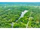 An aerial view showcases homes, a lake, and lush green forestry, all conveniently pinpointed with a location marker at 5858 N West Shore Dr, Morgantown, IN 46160