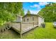 Large outdoor back deck with stairs, handrails, and wooded views is perfect for entertaining and enjoying the outdoors at 5858 N West Shore Dr, Morgantown, IN 46160
