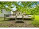 View of the spacious deck and back of home featuring stairs, handrails, and perfect outdoor entertaining possibilities at 5858 N West Shore Dr, Morgantown, IN 46160