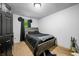 Bedroom with a wood bedframe, a black bedspread, neutral carpet, and a black door at 5858 N West Shore Dr, Morgantown, IN 46160