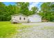 Charming home featuring a white exterior with a large detached garage and a gravel driveway at 5858 N West Shore Dr, Morgantown, IN 46160