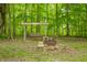 Wonderful back lot featuring a swing, picnic table, and fire pit for Gathering fun and entertaining in a peaceful setting at 5858 N West Shore Dr, Morgantown, IN 46160