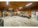 Spacious garage with wooden walls and a concrete floor with a motorized vehicle lift at 5858 N West Shore Dr, Morgantown, IN 46160