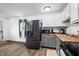 Updated kitchen features stainless steel appliances, butcher block counters, and gray painted cabinets at 5858 N West Shore Dr, Morgantown, IN 46160
