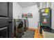 Laundry room with appliances, a black and white rug, and a black door at 5858 N West Shore Dr, Morgantown, IN 46160