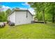 Exterior back view of the metal outbuilding and a portion of the vinyl sided house on the property at 5858 N West Shore Dr, Morgantown, IN 46160