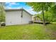 View of the back of the metal outbuilding, including a portion of the vinyl sided house and deck at 5858 N West Shore Dr, Morgantown, IN 46160
