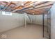 This basement features painted floors, painted block walls, and an unfinished ceiling at 6005 Winthrop Ave, Indianapolis, IN 46220