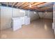 This basement laundry area features painted floors, painted block walls, washer and dryer at 6005 Winthrop Ave, Indianapolis, IN 46220