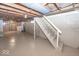 This basement features painted floors, painted block walls, and an unfinished ceiling at 6005 Winthrop Ave, Indianapolis, IN 46220