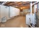 This basement laundry area features painted floors, painted block walls, washer and dryer at 6005 Winthrop Ave, Indianapolis, IN 46220