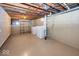 This basement laundry area features painted floors, painted block walls, washer and dryer at 6005 Winthrop Ave, Indianapolis, IN 46220