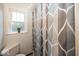 This is a bathroom with a toilet, window, and decorative shower curtain at 6005 Winthrop Ave, Indianapolis, IN 46220