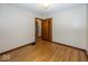 This bedroom features wood trim, wood floors, and a neutral wall color at 6005 Winthrop Ave, Indianapolis, IN 46220