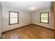 Cozy bedroom with hardwood floors and windows that offer natural light at 6005 Winthrop Ave, Indianapolis, IN 46220