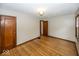 Comfortable bedroom with hardwood floors and convenient access to other rooms at 6005 Winthrop Ave, Indianapolis, IN 46220