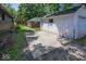 Exterior view showcasing the detached garage and concrete parking pad at 6005 Winthrop Ave, Indianapolis, IN 46220
