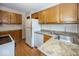 Practical kitchen featuring granite countertops and oak cabinetry at 6005 Winthrop Ave, Indianapolis, IN 46220