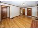 Spacious living room featuring hardwood floors, classic trim, and multiple doorways at 6005 Winthrop Ave, Indianapolis, IN 46220