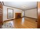 Bright living room with a charming fireplace, hardwood floors, and large windows at 6005 Winthrop Ave, Indianapolis, IN 46220