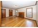 Inviting living room with hardwood floors, a classic fireplace, and natural light at 6005 Winthrop Ave, Indianapolis, IN 46220