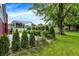 The backyard features a house and manicured landscaping and a well maintained lawn at 602 Pioneer Dr, Indianapolis, IN 46217