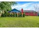 The backyard has a brick house, blue siding, and green landscaping with privacy at 602 Pioneer Dr, Indianapolis, IN 46217