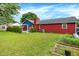 The backyard has a well-kept lawn with a patio and is surrounded by green landscaping at 602 Pioneer Dr, Indianapolis, IN 46217